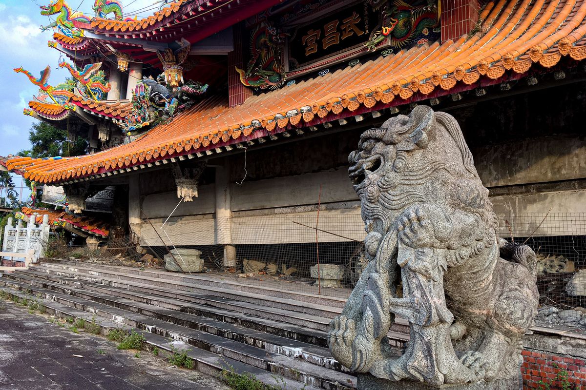 地震で崩れた寺院に鎮座する狛犬